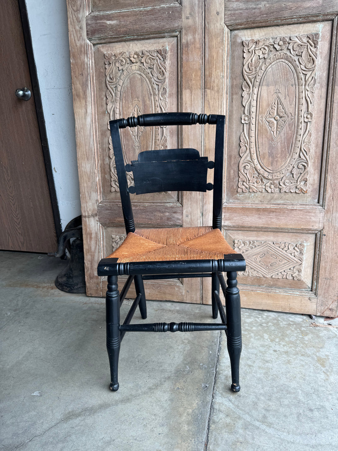 Black chair with woven seat