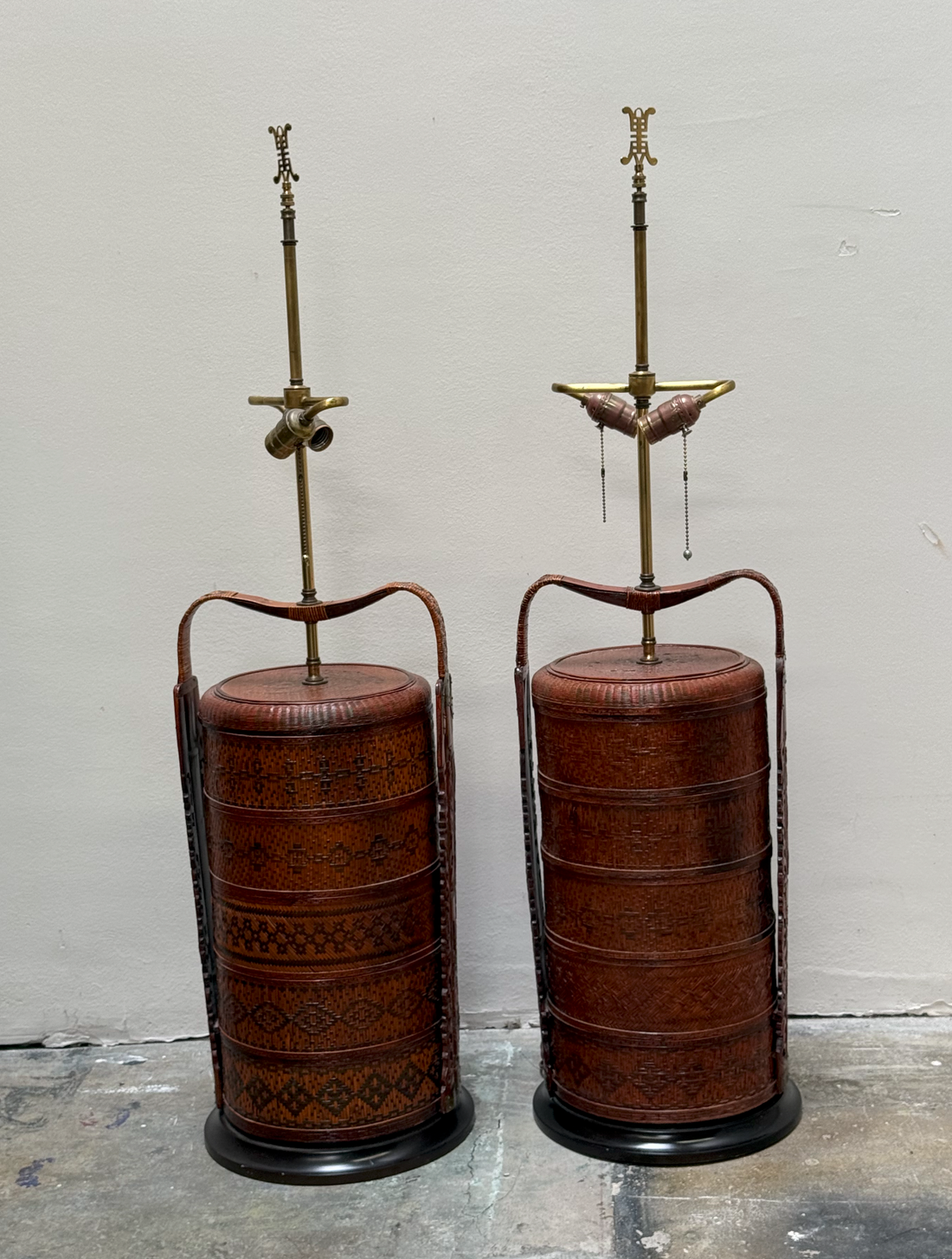 Vintage woven rattan basket-form  lamps with brass hardware and bent rattan handles (Pair)